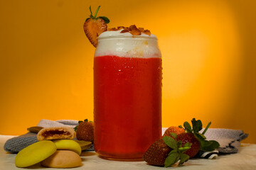 Fresh cold strawberry juice with whipped cream and strawberry slices