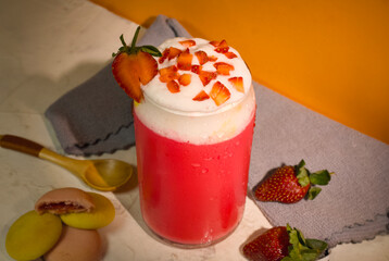 Top view of Fresh cold strawberry juice with whipped cream and strawberry slices