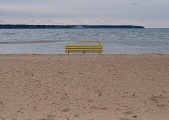 Yellow bench on the baltic beach