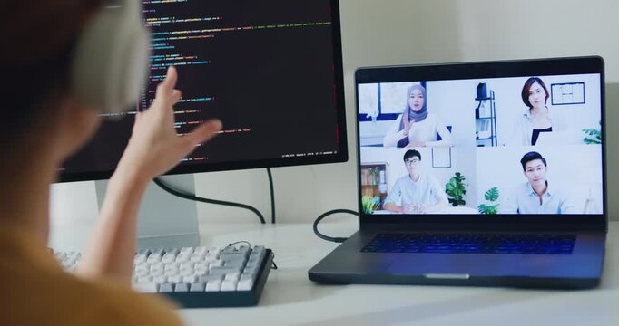 Closeup young Asia female programmer meeting video conference discuss work prompt AI bot IT app program nomad, game, terminal coding, user interface, data center on desktop computer at home office.
