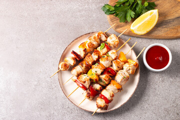 Grilled chicken skewers. Satay with side lemon and salad. Kebab with sauces. 