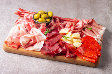 Charcuterie board. Antipasti appetizers of meat and cheese platter with salami, prosciutto crudo or jamon and olives