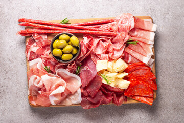 Charcuterie board. Antipasti appetizers of meat and cheese platter with salami, prosciutto crudo or jamon and olives