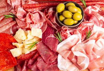 Charcuterie board. Antipasti appetizers of meat and cheese platter with salami, prosciutto crudo or jamon and olives