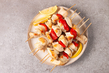 Grilled chicken skewers. Satay with side lemon and salad. Kebab with sauces. 