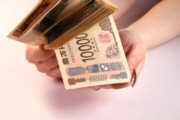 1万円札と女性の手