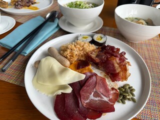 A delicious Vietnamese breakfast spread, including bacon, cured meats, cheese, dried squid, and local soup. Perfect morning meal in Cam Ranh