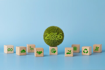 2026 sustainability concept with green world and eco icons on wooden cubes, for business ESG strategy, net zero targets, circular economy, clean energy, AI efficiency, recycling and responsible growth
