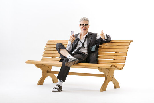 Happy homeless unemployed businessman using a job search app