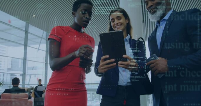 Three professionals in business attire sharing ideas in office lounge, with coffee mug and tablet