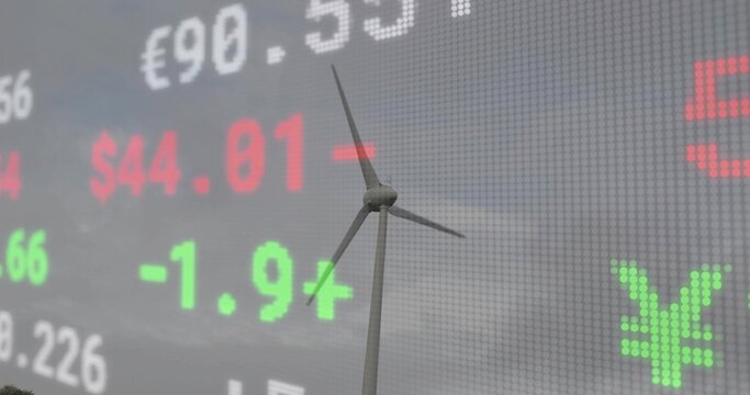 Spinning wind turbine appearing over LED ticker backdrop, with currency symbols, stock prices