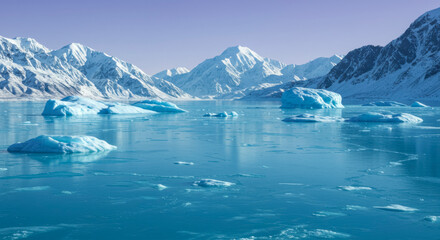 Snow-capped mountain range meeting a glacial turquoise sea with floating icebergs under a soft violet sky in a cold arctic landscape
