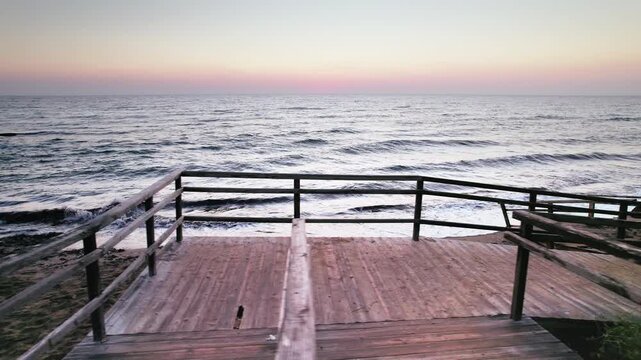 Ancient Stairs on Sandy Long Beach at Dawn: Waves Caressing the Shore in Iskele, Northern Cyprus