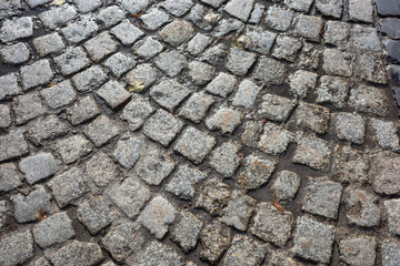 Cobblestone pavement with wet surface