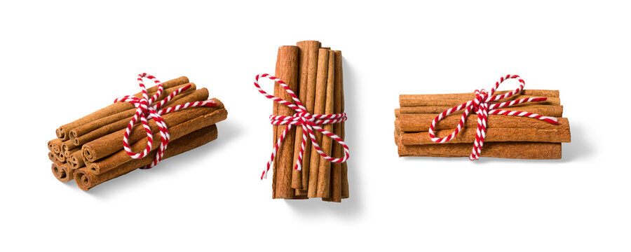 Three bundles of cinnamon sticks tied with red and white twine isolated on a transparent background, PNG. High resolution. Natural Aromatic Spice for Cooking and Baking - Powered by Adobe