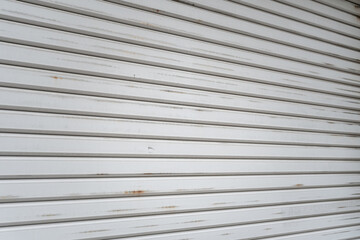Obraz premium Metal grate rolling door of the warehouse storage or service garage.
