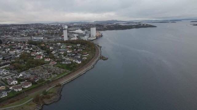Aerial drone footage showing railroad train tracks stretching into the distance under overcast, gloomy evening weather. The scene captures a quiet and moody atmosphere with muted tones and soft light.