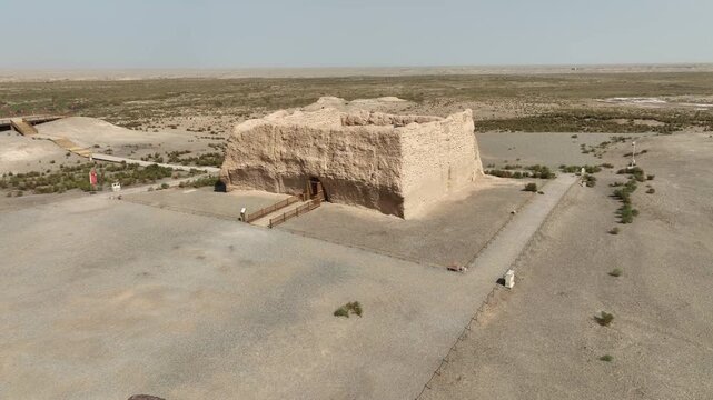 Aerial view of the crumbling Yumen Pass fortress in the vast desert landscape, a stark contrast between the ancient structure and the arid surroundings, Yumen, Gansu, China.