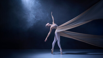 Ballet dancer wrapped in stretched fabric performing balanced backbend. Concept of movement control, stage flexibility, professional dance art, and studio lighting setup.