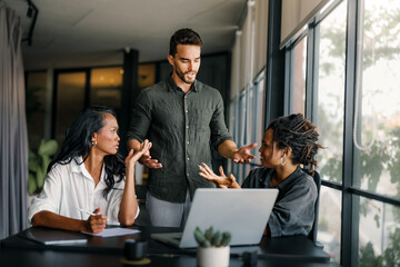 Business colleagues having a misunderstanding and arguing during a meeting in a modern office