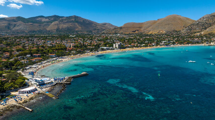 Fototapeta premium Aerial view of Mondello Beach near Palermo, Sicily, Italy. It's a beautiful bay and a popular tourist destination for Sicilian summer vacations. The sea ranges in color from blue to turquoise.