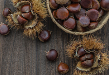 Background with chestnuts on a wooden table