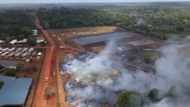 Aerial clip of a wild grass fire and smoke at the edge of a remote community in Cape York, Australia. Clip 2