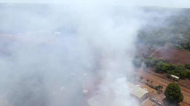 Aerial clip of a wild grass fire and smoke at the edge of a remote community in Cape York, Australia. Clip 3