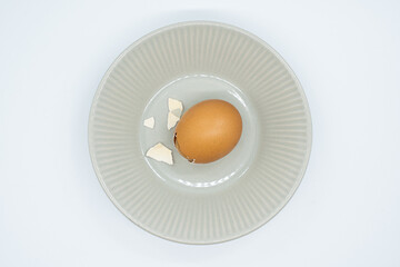 Boiled eggs in a circular bowl on a white background
