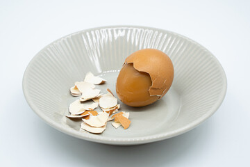 Boiled eggs in a circular bowl on a white background