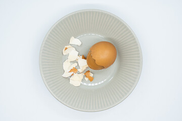 Boiled eggs in a circular bowl on a white background