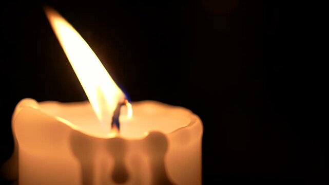 Burning Candle in Darkness.