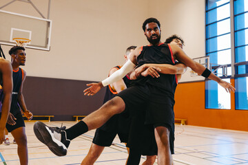 Basketball players engaged in intense action