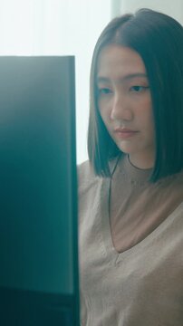 Vertical Screen : Young Asia female freelance typing write prompt AI bot IT app program nomad, video game, terminal with coding language, user interface, designer, big data center on desktop computer.