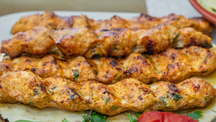 Lula kebab chicken. Grilled minced chicken skewers on a plate