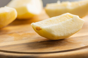 fresh crispy apple slice on wooden cutting board close up