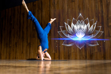 Woman practicing yoga headstand pose with lotus flower