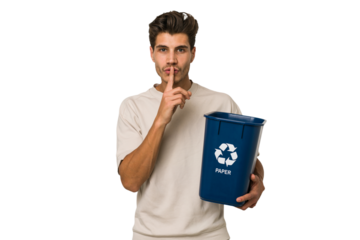 Young caucasian man holding a paper trash for recycle keeping a secret or asking for silence.