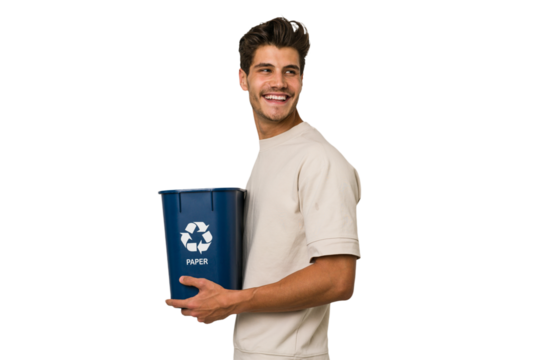Young caucasian man holding a paper trash for recycle looks aside smiling, cheerful and pleasant.