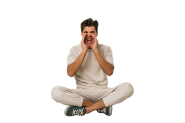 Young caucasian man sitting on the floor isolated on white background shouting excited to front.