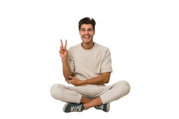 Young caucasian man sitting on the floor isolated on white background showing number two with fingers.