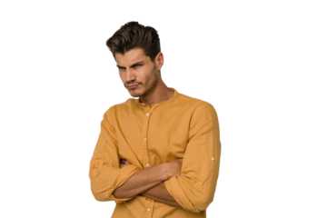 Young handsome caucasian man isolated on white background frowning face in displeasure, keeps arms folded.