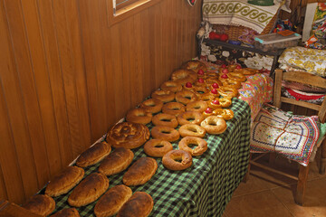 baked goods golden brown bread rolls. Some contain red-dyed eggs embedded in the dough, reflecting festive Easter traditions in Olympos, Dodecanese, Karpathos Island, Greece,