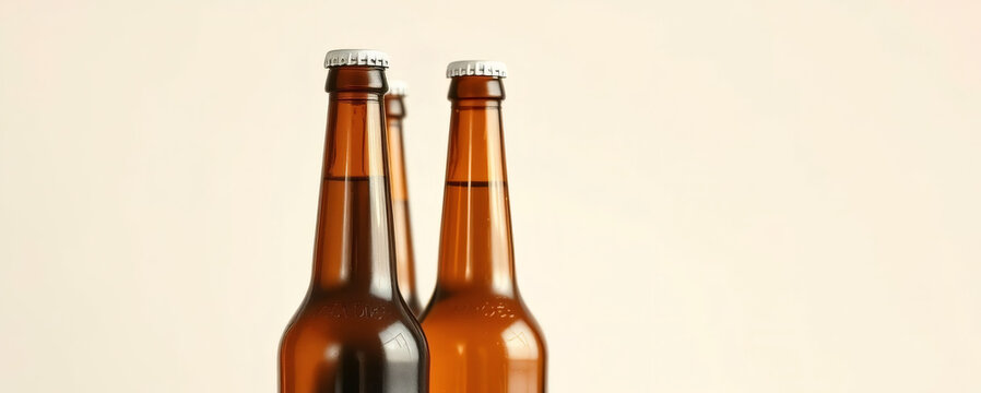 Brown glass bottles of beer standing together against a soft neutral background, perfect for beverage promotion and marketing