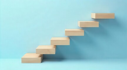 Ascending wooden blocks arranged in a staircase formation against a simple backdrop symbolizing progress and upward mobility