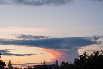 A breathtaking sunset scene with pink and orange hues and fluffy clouds in the background.