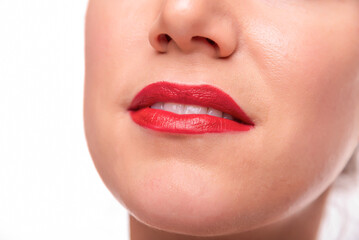 Fototapeta premium A smiling woman with red lipstick showing clean white teeth, representing beauty, confidence, and feminine elegance.