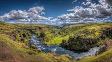 Scenic landscape of river and green hills under a bright blue sky