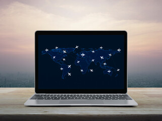Flight routes airplanes connection and world map on laptop screen on table over city tower at sunset sky, vintage style, Airplane transportation network, Elements of this image furnished by NASA © grapestock