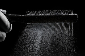 Hairbrush in Motion with Mist Spray &ndash; Black and White Hygiene Concept.